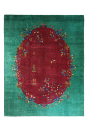 Art Deco Chinese rug featuring an oval ruby medallion adorned with delicate floral sprays and lanterns, set against a rich emerald green background.